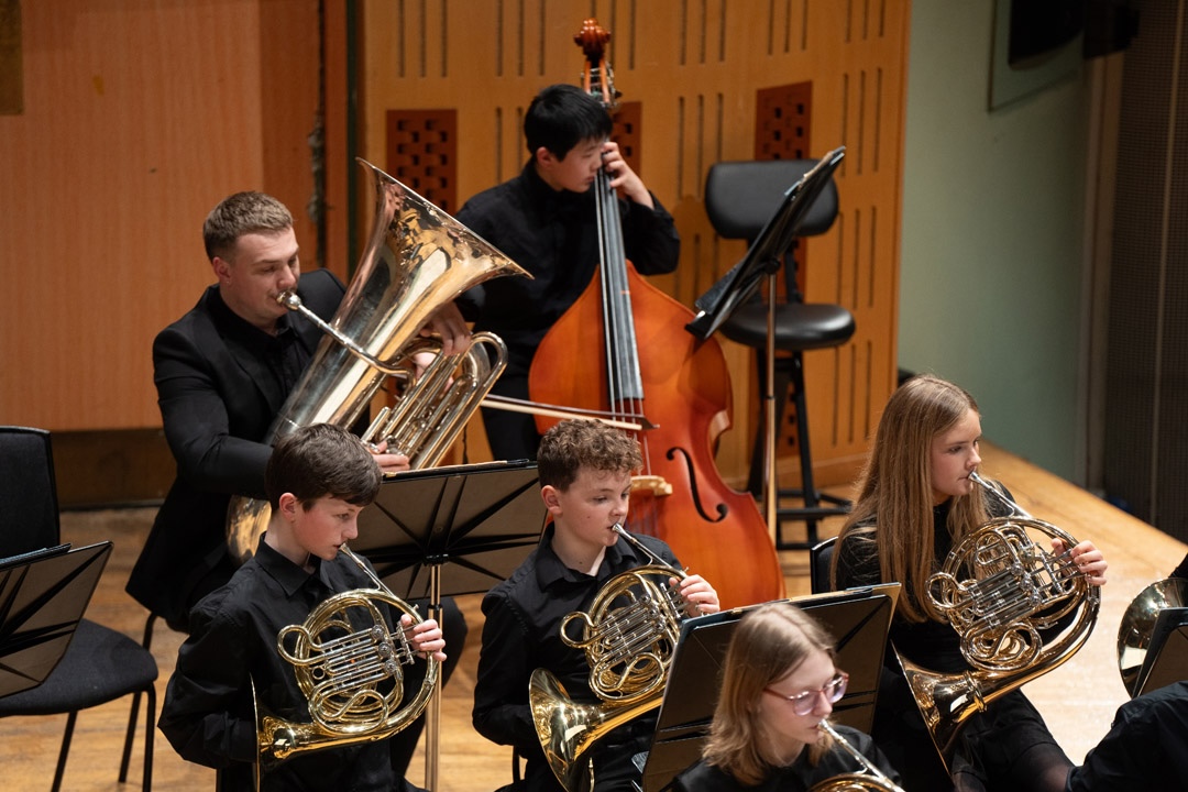 Children playing brass and string instruments